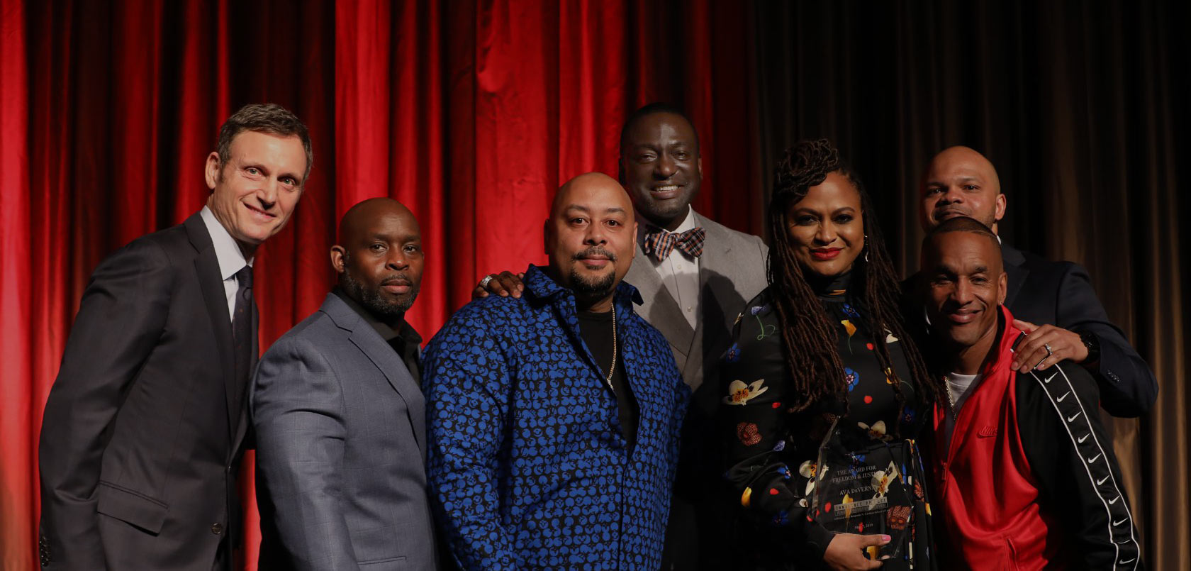 Tony Goldwyn, Antron McCray, Raymond Santana, Yusef Salaam, Korey Wise, and Kevin Richardson presenting Ava DuVernay with a Champion of Justice Award at the May 2019 Innocence Project benefit. Photo by Innocence Project/Matthew Adam Photography. 