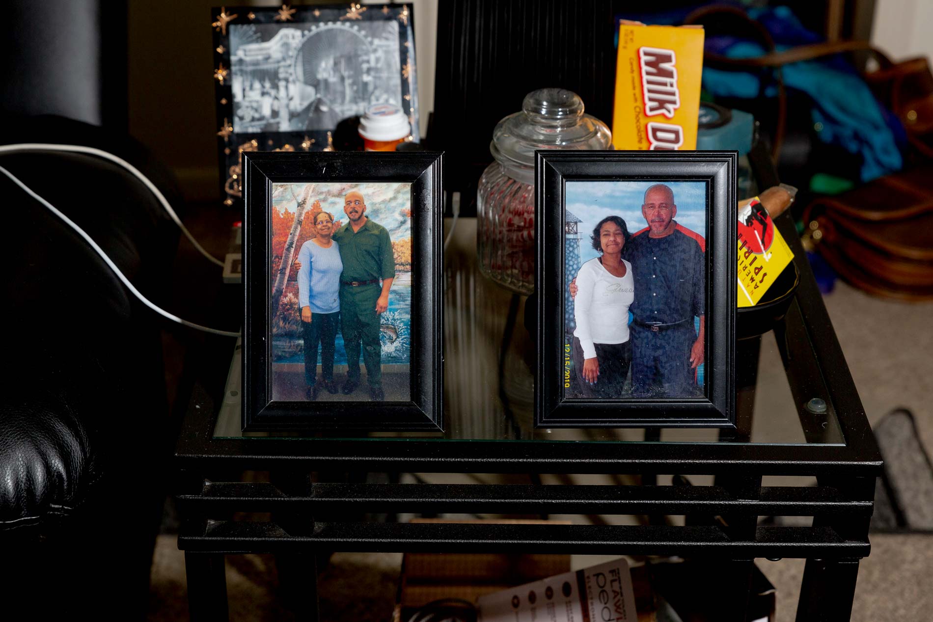 Photos of Gerry Thomas with his sister (left) and niece (right) while he was in prison sit on a table in his apartment in Sterling Heights, Michigan on Feb. 7, 2022. (Image: Sylvia Jarrus/Innocence Project)