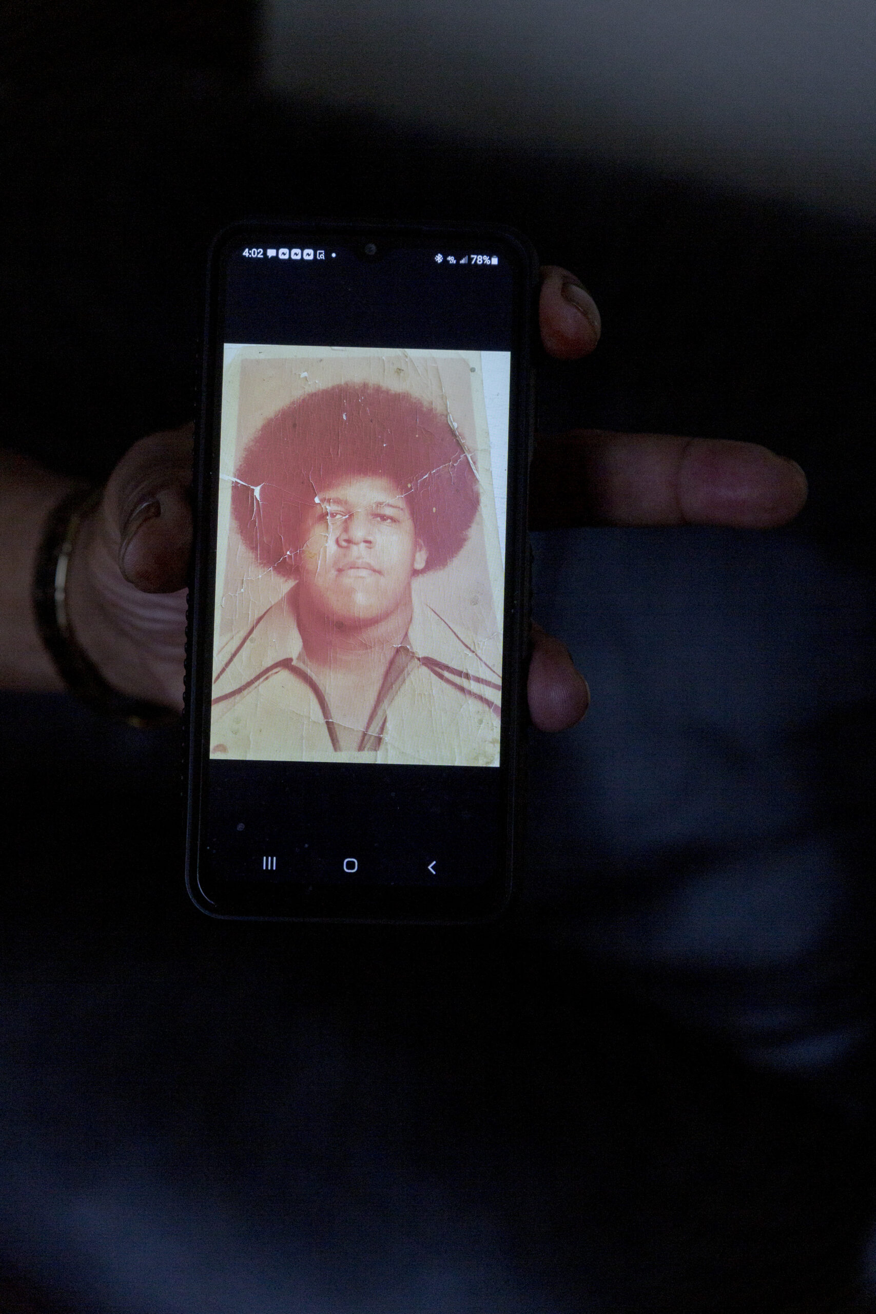 Gerry Thomas shows an old photo of himself as a 14-year-old inside of his apartment in Sterling Heights, Michigan, on Feb. 7, 2022. (Image: Sylvia Jarrus/Innocence Project)