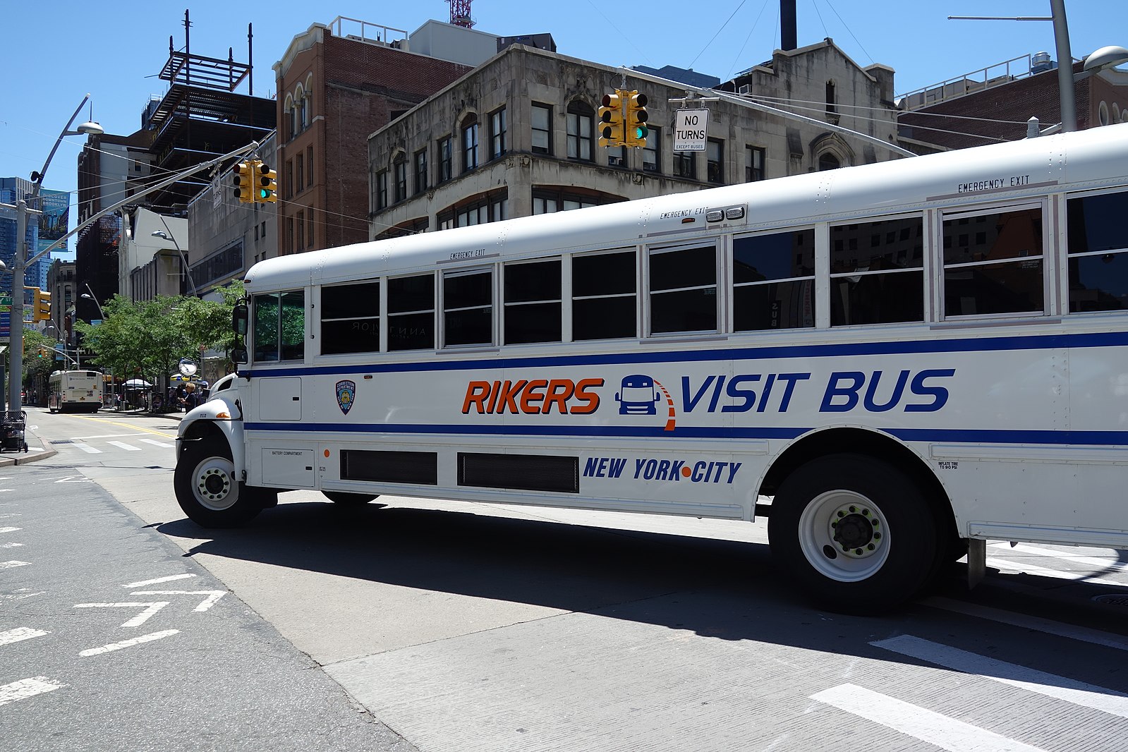 A Rikers Island Visit Bus turning north from Fulton Mall onto Jay Street in Downtown Brooklyn. [Tdorante10/Wikimedia Commons]