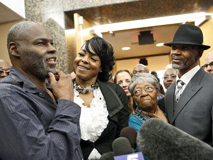Stanley Mozee (left) and Dennis Allen (right) are greeted by family, supporters and the media after being released in Dallas in 2014. (Image: Lara Solt)