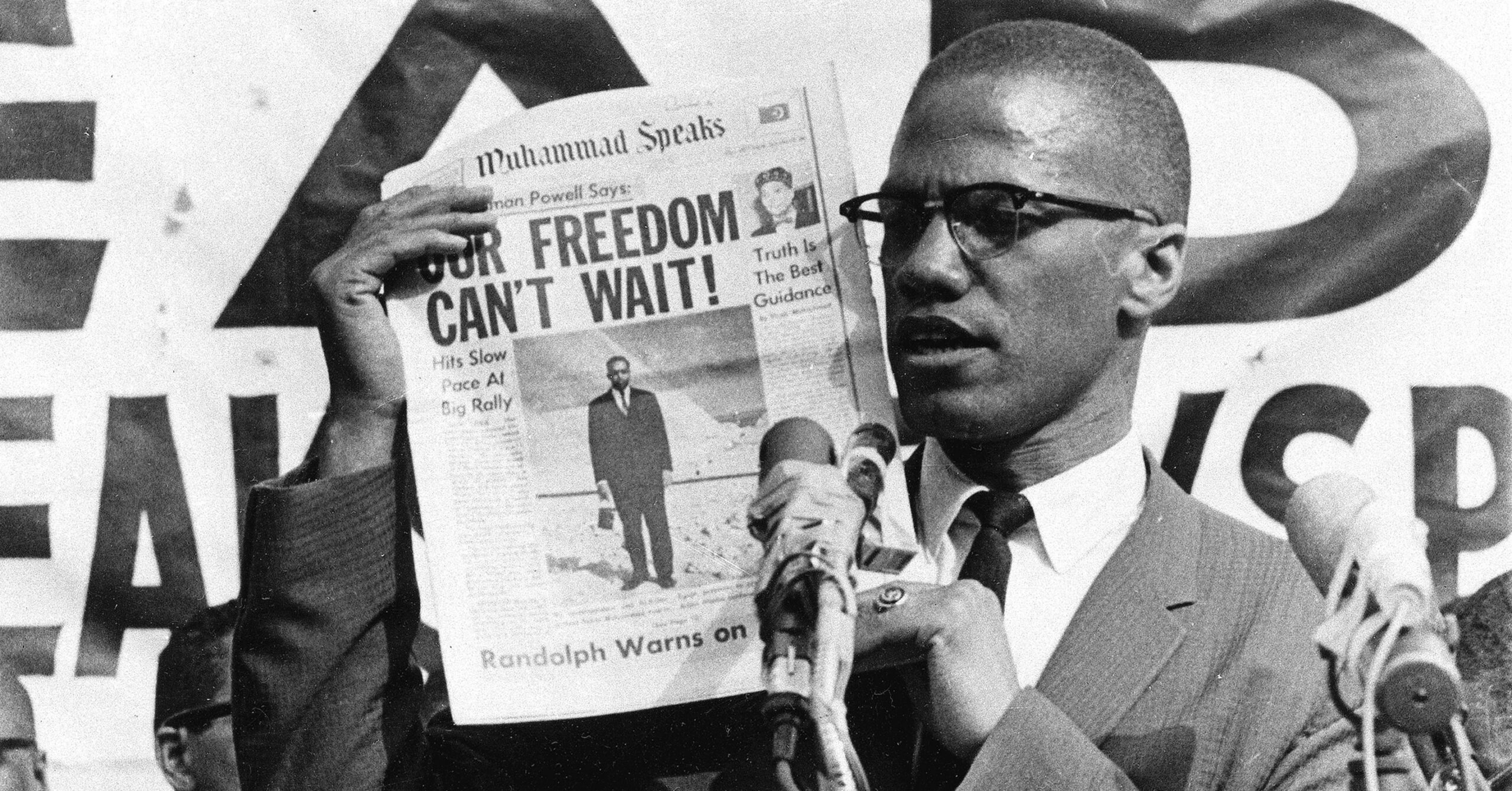 Malcolm X holds up a paper for the crowd to see during a rally in New York City on Aug. 6, 1963. (Image: AP Photo)