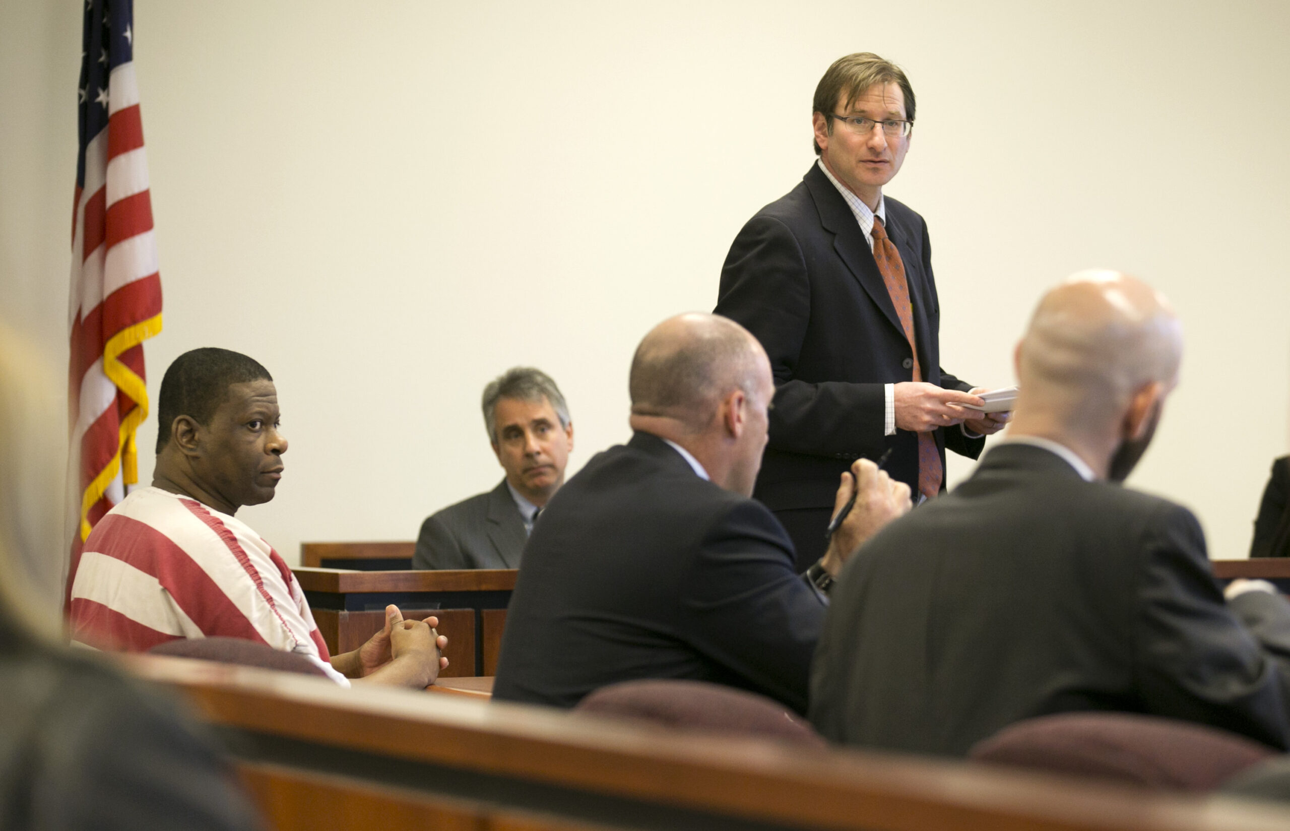 Rodney Reed, left, listens as his attorney Bryce Benjet, standing at right, speaks at a hearing at the Bastrop County Criminal Justice Center in Bastrop on Tuesday November 25, 2014.  (Jay Janner/Austin American-Statesman via AP)