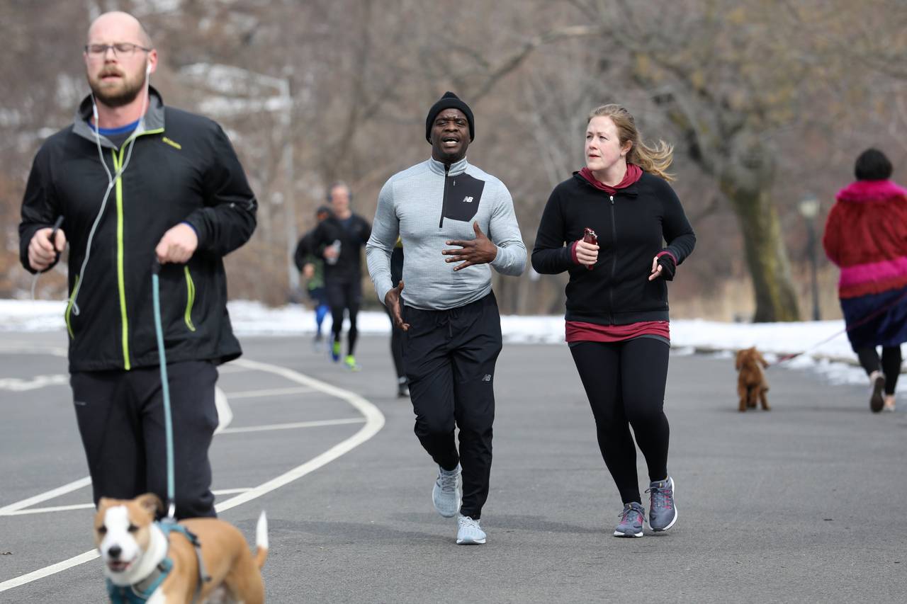 Mark Denny, center, and Sara Doody, who worked on his case while interning at the Innocence Project, finish a two-lap run around Prospect Park. PHOTO: BESS ADLER FOR THE WALL STREET JOURNAL
