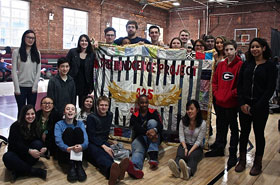 Students from Berkeley Carroll school with quilt.