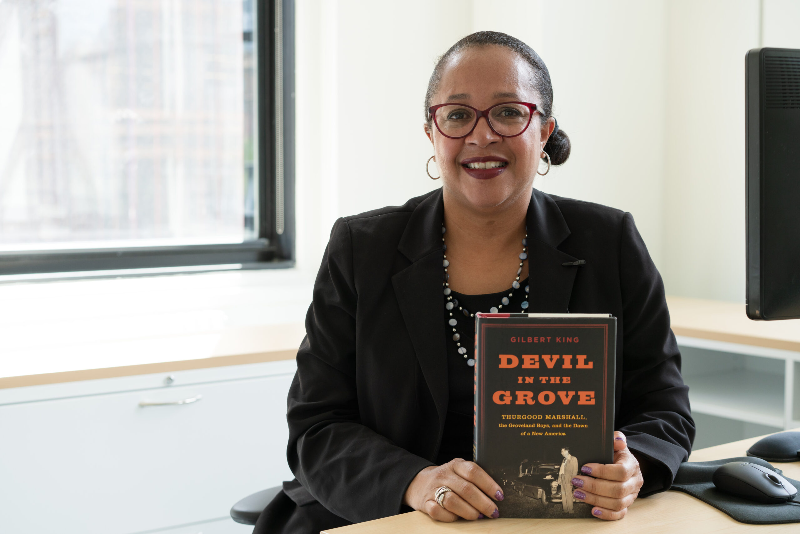 Christina Swarns, Innocence Project's new executive director visiting the office in September 2020. She's holding up one of her favorite books, 