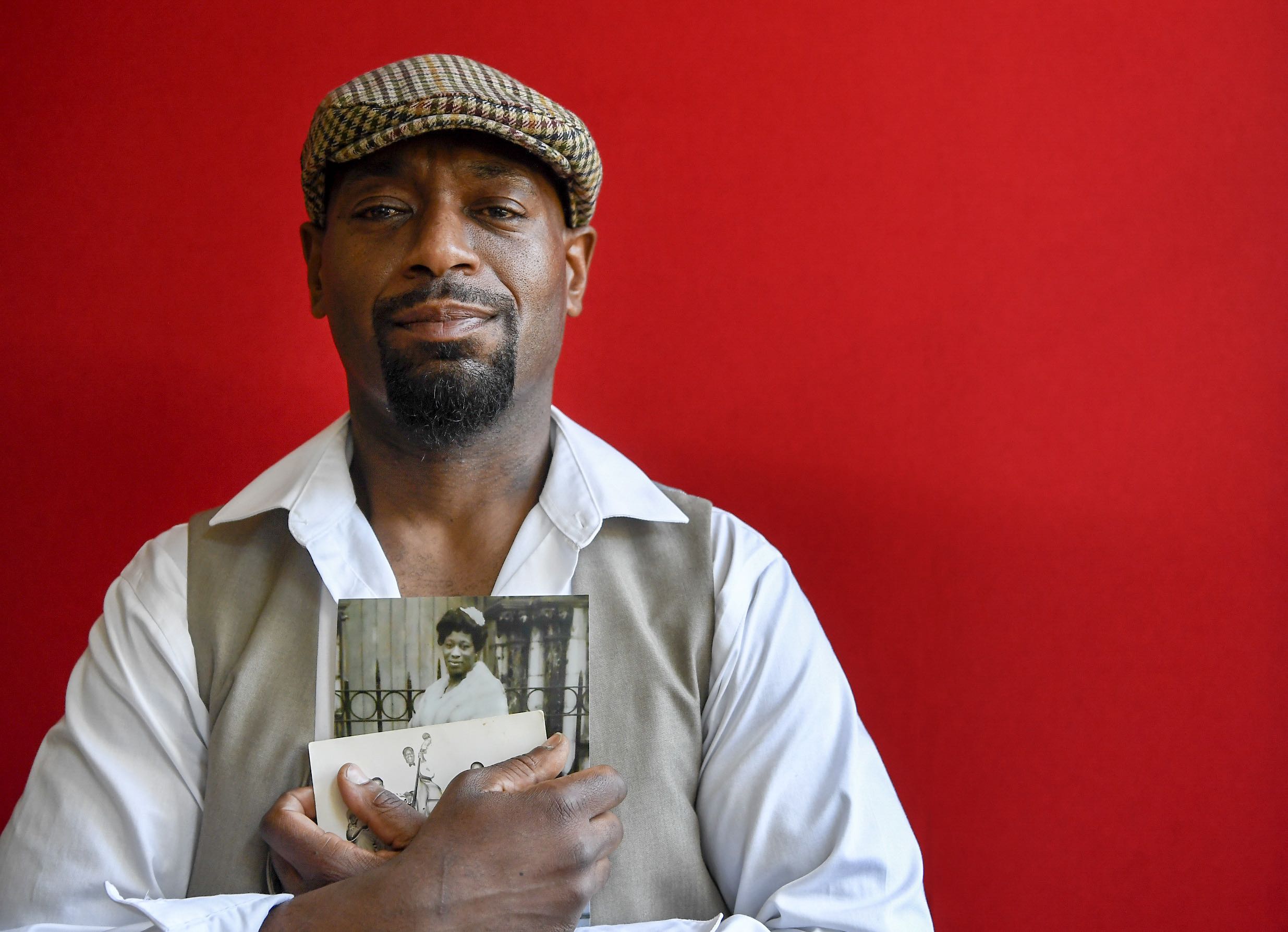 Huwe Burton holding a picture of his mom  Keziah Burton. Photo by Lacy Atkins. 