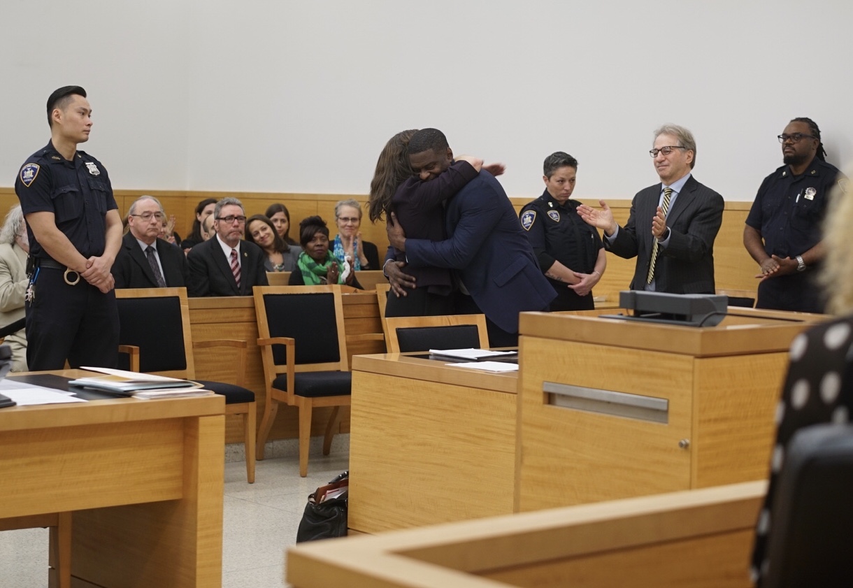 Mark Denny hugs his attorney Nina Morrison along side Barry Scheck, moments after he was exonerated. Photo by Sameer Abdel-Khalek. 