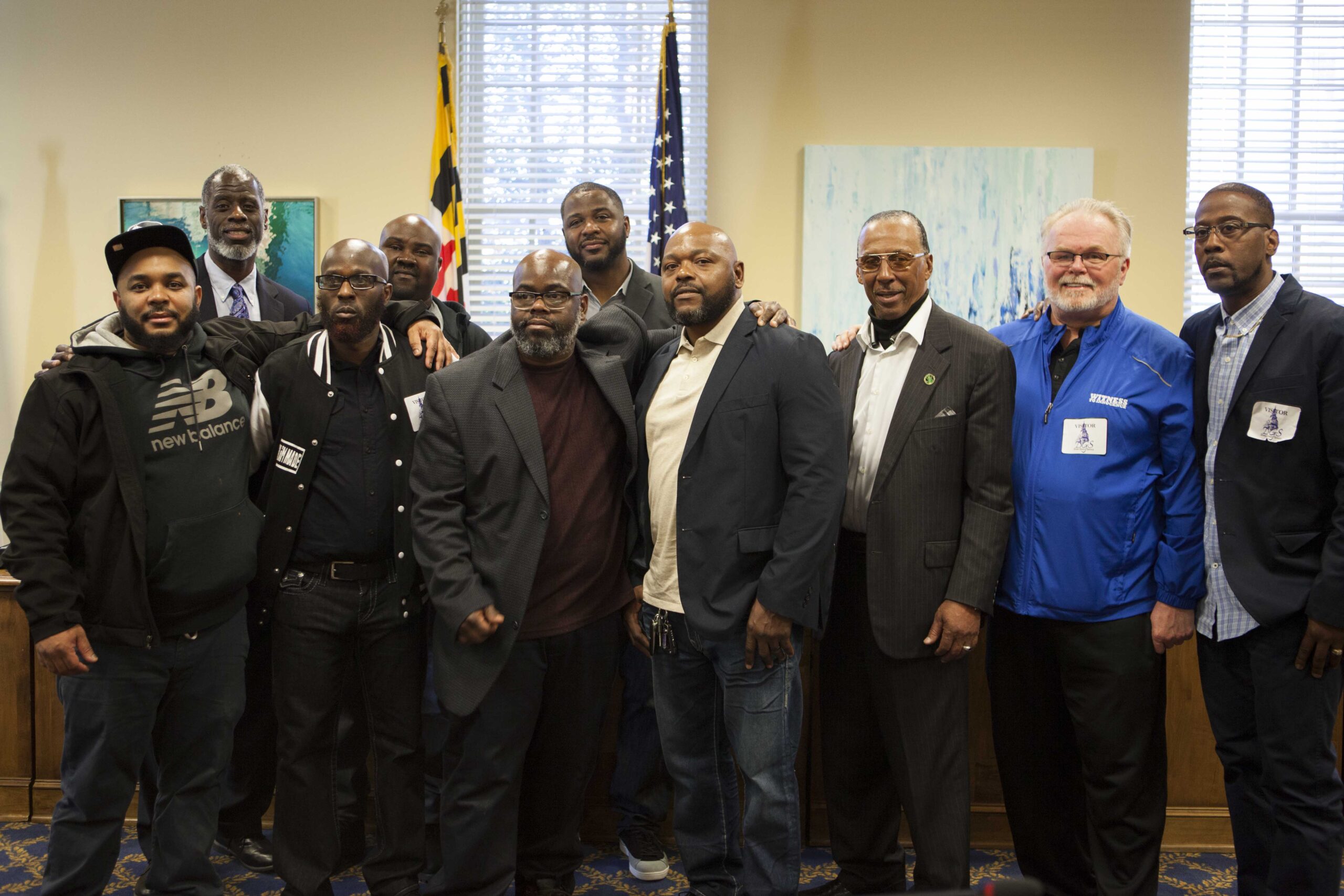 Exonerees from Maryland gather at the State House to share their stories in January 2020. Pictured from left to right: Demetrius Smith, Ransom Watkins, Eric Simmons, Lamar Johnson, Kenneth JR McPherson, Jermaine Arrington, Clarence Shipley, Walter Lomax, Kirk Bloodsworth, and Alfred Chestnut. (Image: Daniele Selby/Innocence Project)