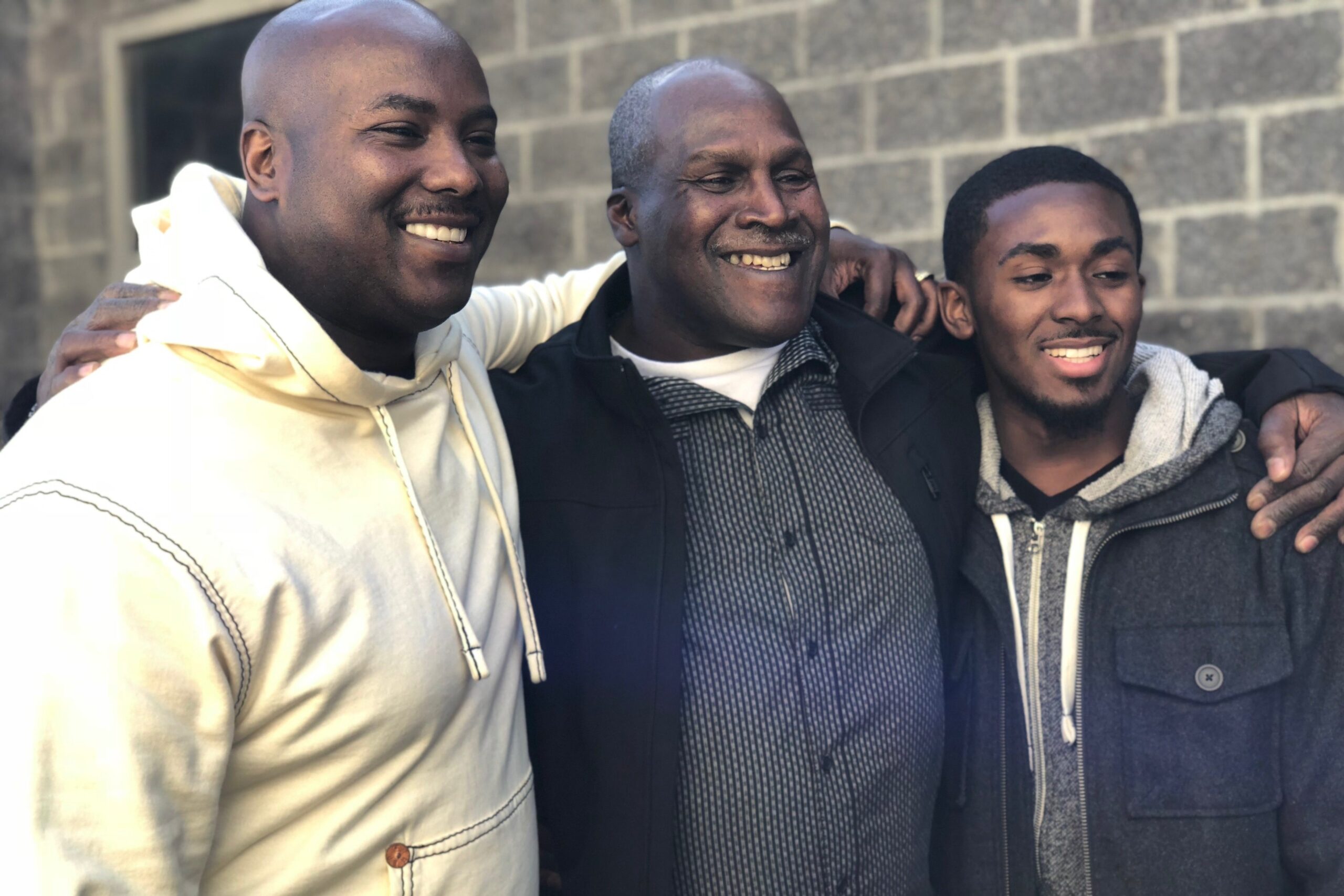 Malcolm Alexander, center, with his son and grandson--also named Malcolm--on the day he was exonerated. January 30, 2018. Photo: Innocence Project.
