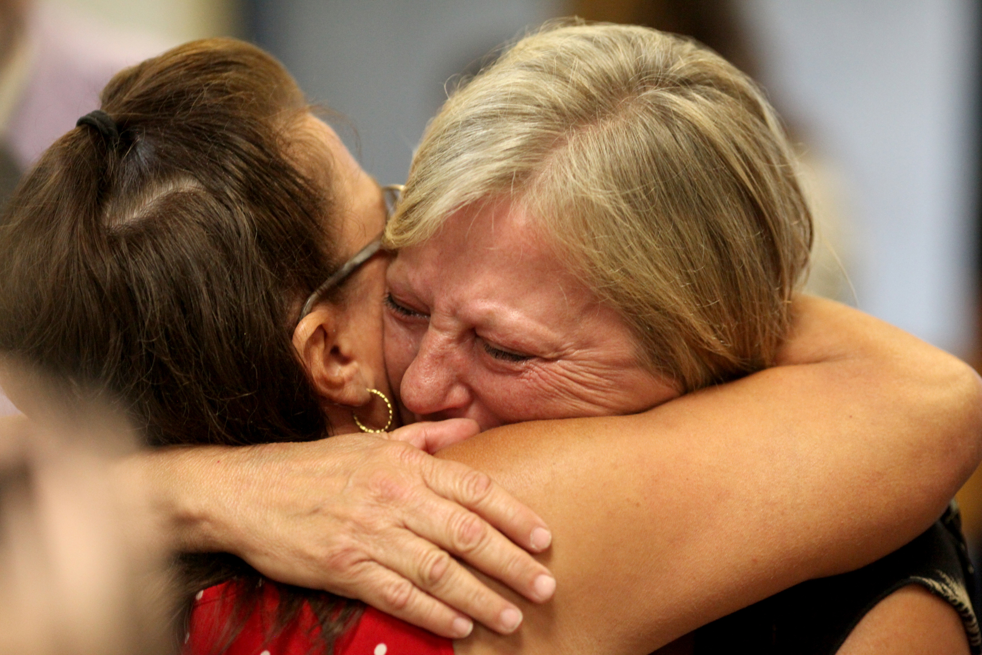 Defendents' families embrace at hearing in summer 2016. Aaron Borton/ Innocence Project