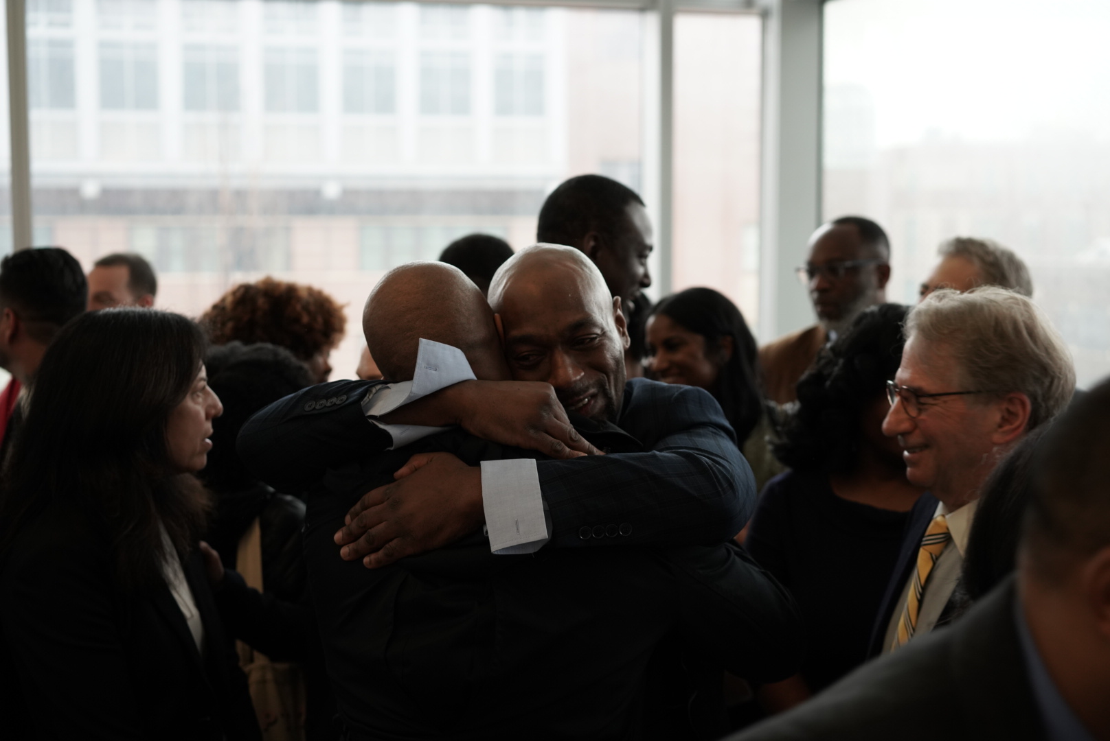 Huwe Burton hugging a family member following his exoneration.