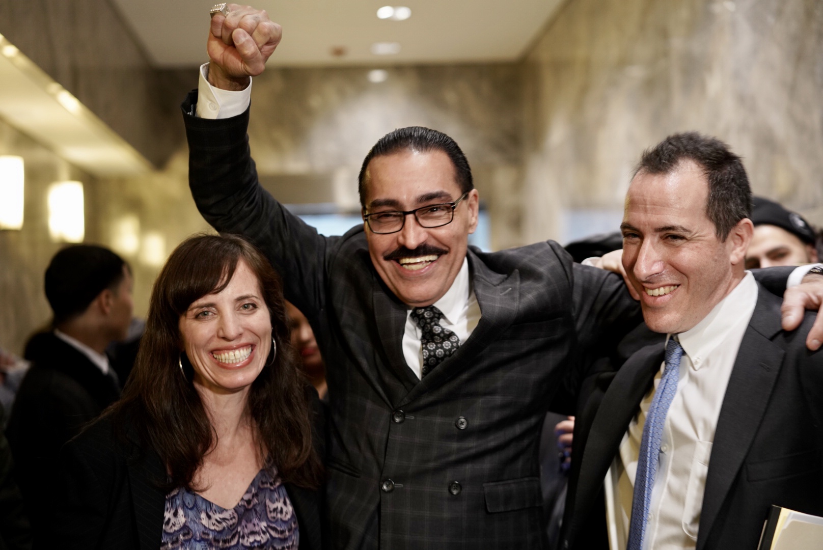 Felipe Rodriguez (center) after his hearing with his attorneys Nina Morrison, senior litigation counsel at the Innocence Project, (left), and Zachary Margulis-Ohnuma (right), at the Queens County Supreme Court on Dec. 30. Credit: Sameer Abdel-Khalek for the Innocence Project.