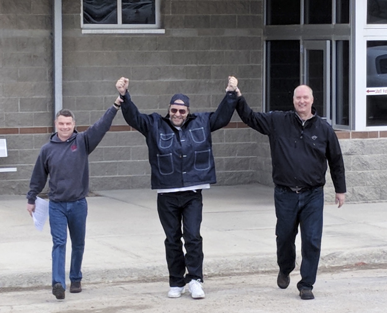 Freddie Joe Lawrence, center, walking out of Montana State Prison with his lawyers, Toby Cook, left, and Larry Mansch of the Montana Innocence Project. Photo by Thomas Plank.
