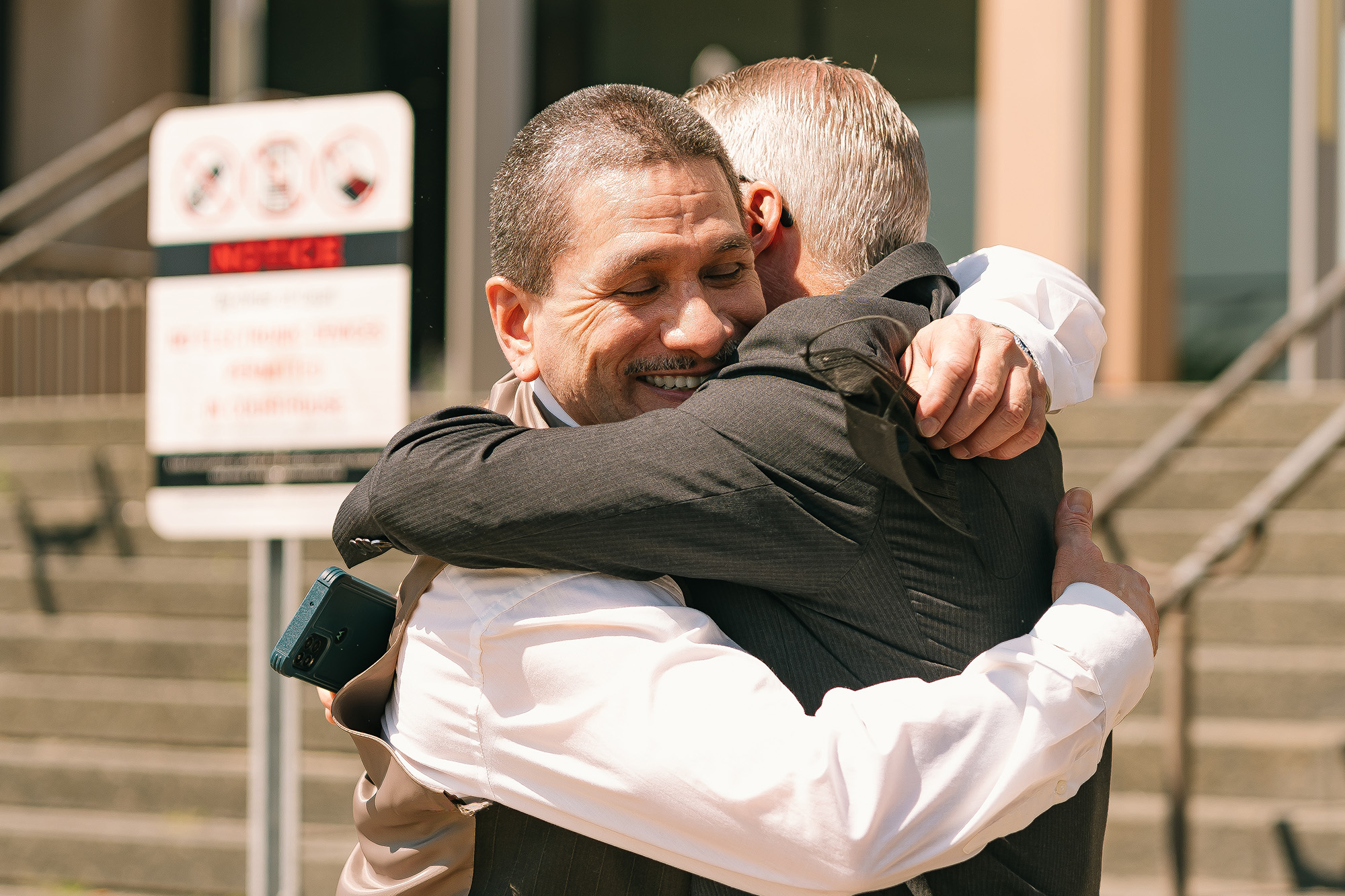 John Galvan hugs a member of his legal team after his exoneration on July 22, 2022. (Image: Ray Abercrombie/Innocence Project)