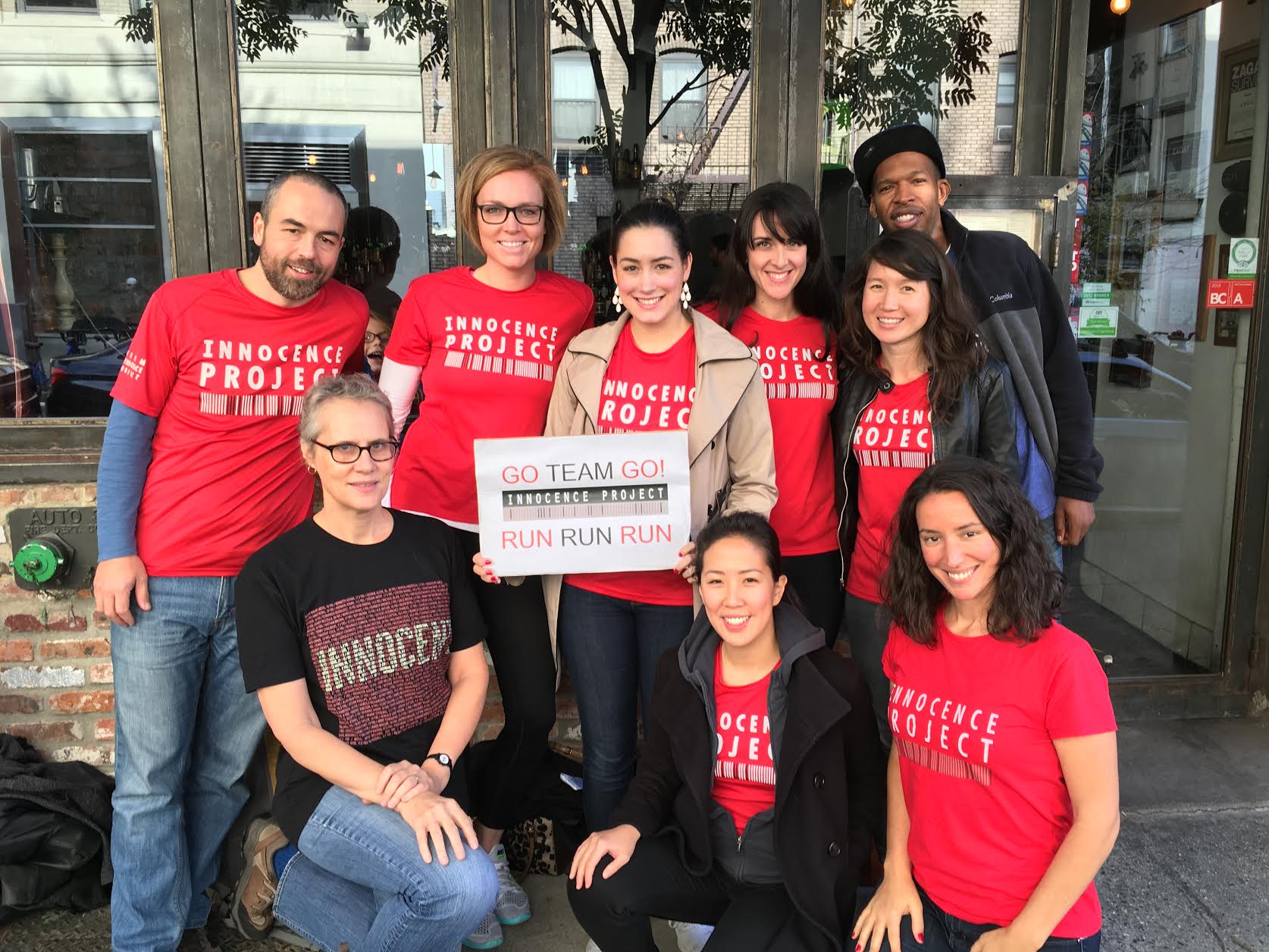 Executive Director, Maddy deLone and IP Staffer Laura Ma (front row left and center) and IP staffer Kareem Belt (top right) pictured here with prior Team Innocence Project TCS Marathon members.