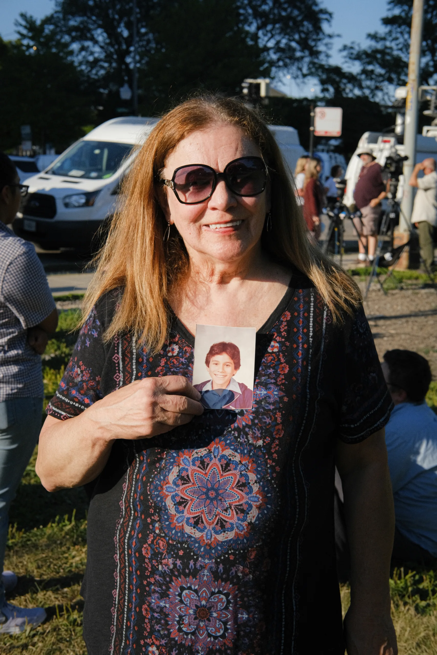 John Galvan's mother, Linda Flores, holds a photo of young John. (Image: Tori Howard/Innocence Project)