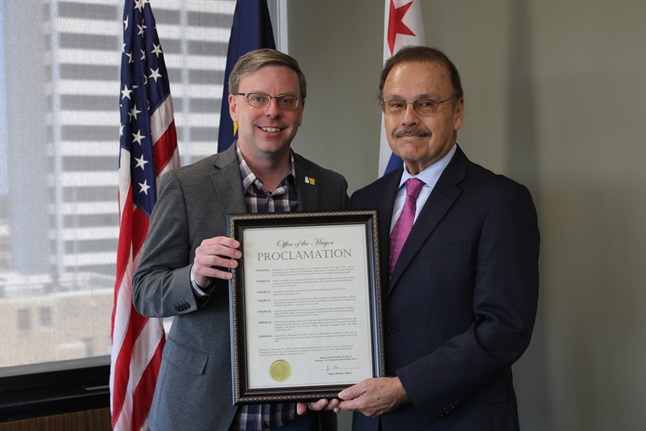 South Bend Mayor Mueller presenting the proclamation to Clinic Director Jimmy Gurulé.