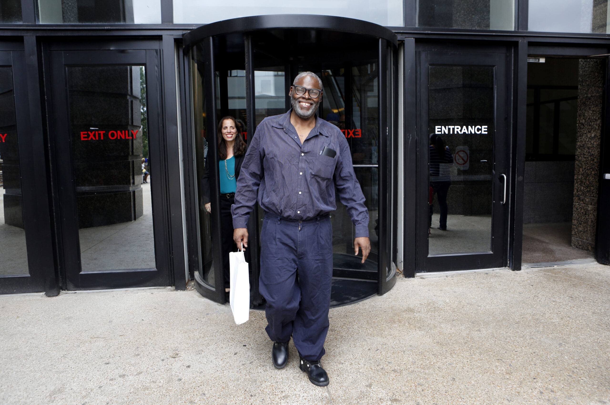 Stanley Orson Mozee, represented by the Innocence Project and Attorney Nina Morrison (background), takes his first steps on the outside after Judge Mark Stoltz overturned his conviction for murder because of prosecutorial misconduct at the Frank Crowley Courts Building on Tuesday, October 28, 2014. (Photo copyright Lara Solt)