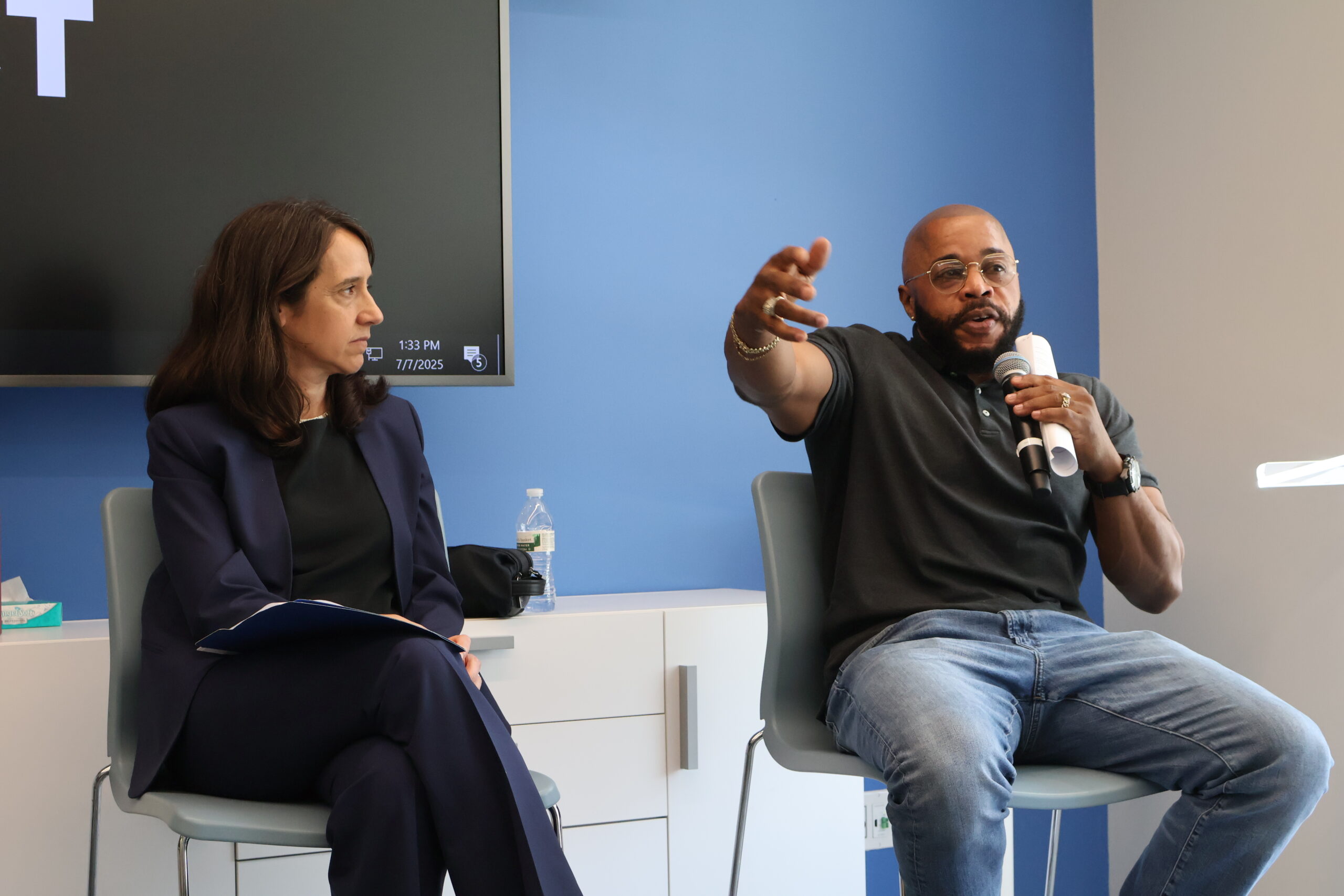 Director of Post-conviction Litigation Anastasia Heeger and Innocence Project exoneree Norberto Peets speak with associates from Davis, Polk and Wardell at Innocence Project offices. (Photo: Louise Liu for Innocence Project)